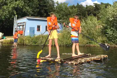 zwei Jungen auf einem selbst gebauten Floß